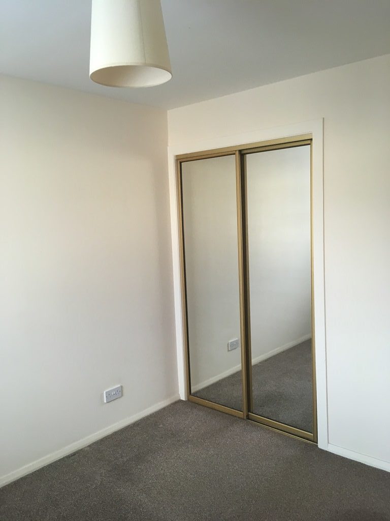 Bedroom with mirror doors  