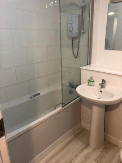 bathroom with shower over bath